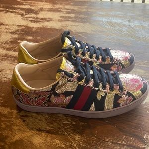 Gucci Lotus flowered tennis shoes.